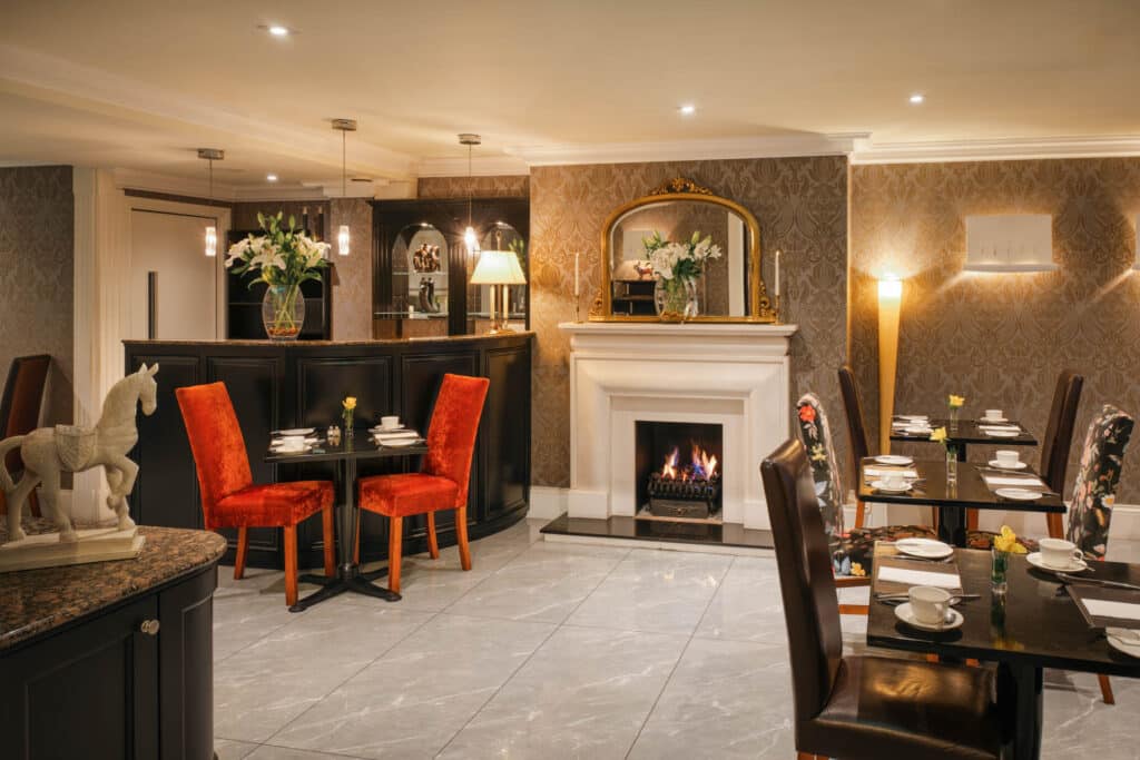 Hotel dining area with tables set and traditional décor.