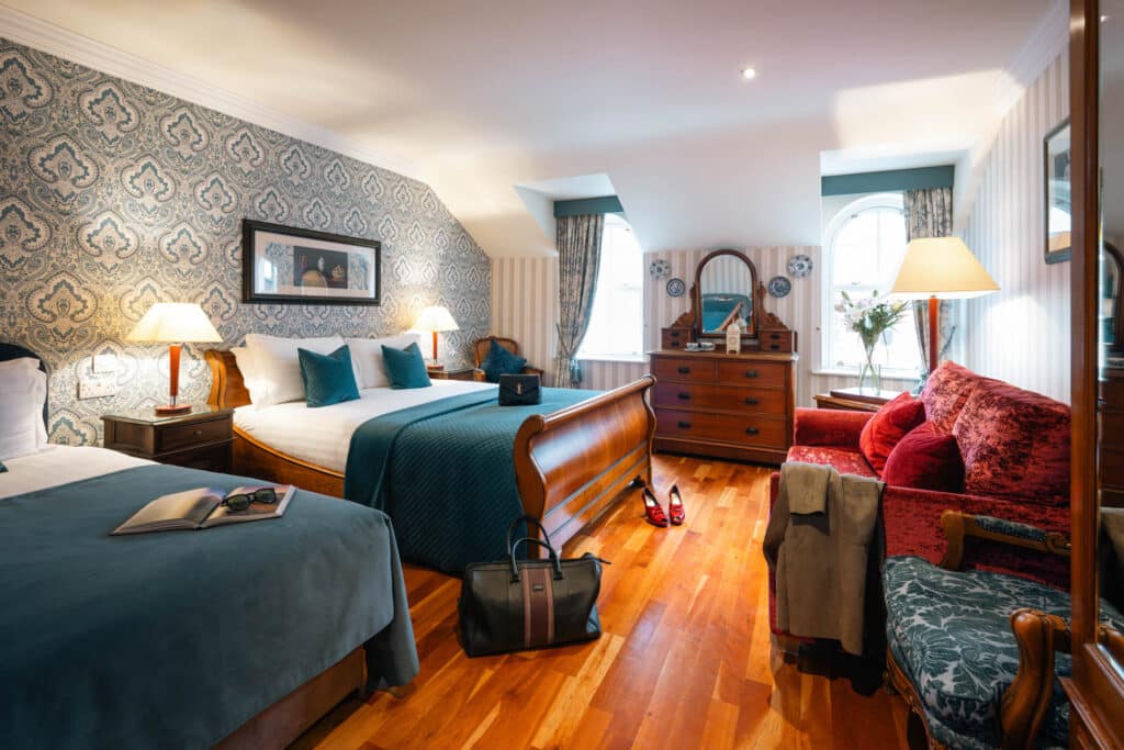 Open-plan junior suite showing lounge seating and sleeping area.